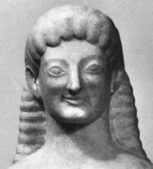 A black and white photo of a Greek statue with an archaic smile